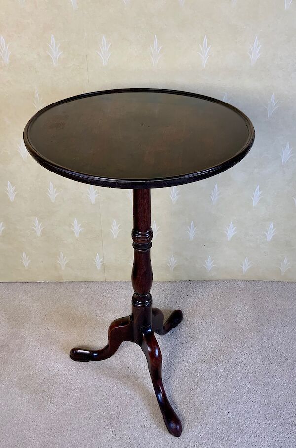 A mahogany tripod wine table