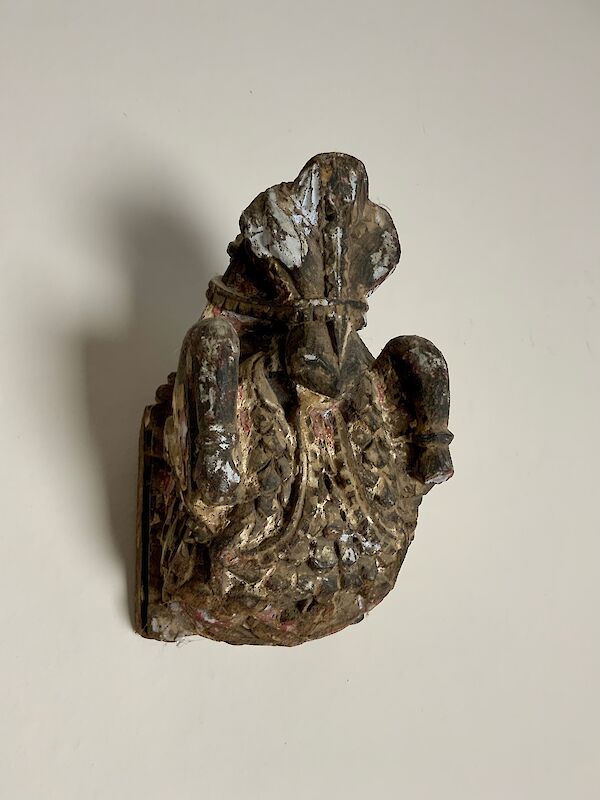 A carved oak and polychrome corbel