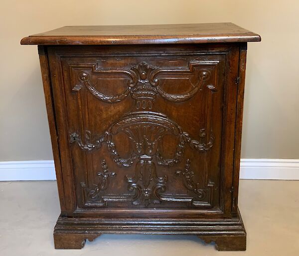 An Italian carved walnut cabinet
