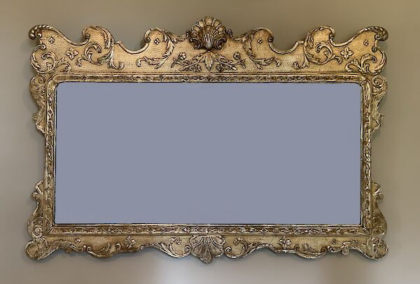 A silver gilt framed mirror